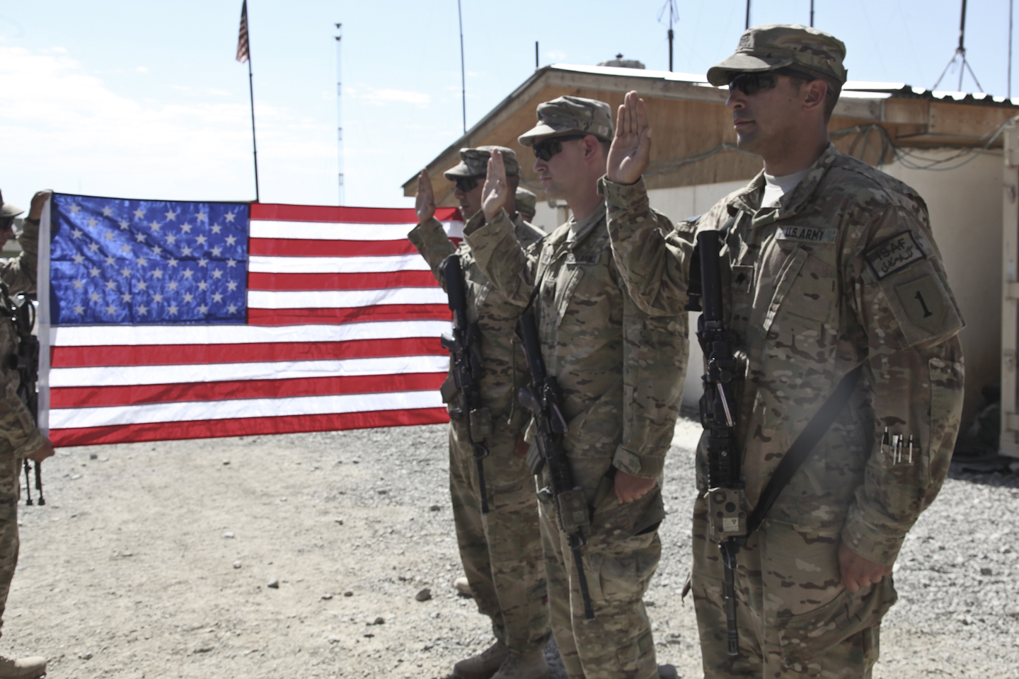 U.S. soldiers assigned to Bravo Company, 2nd Battalion, 16th Infantry Regiment, 1st Infantry Division, prepare to take the Oath of Enlistment during a re-enlistment ceremony at Combat Outpost Bande Sardeh, Ghazni province, Afghanistan, July 3, 2012.