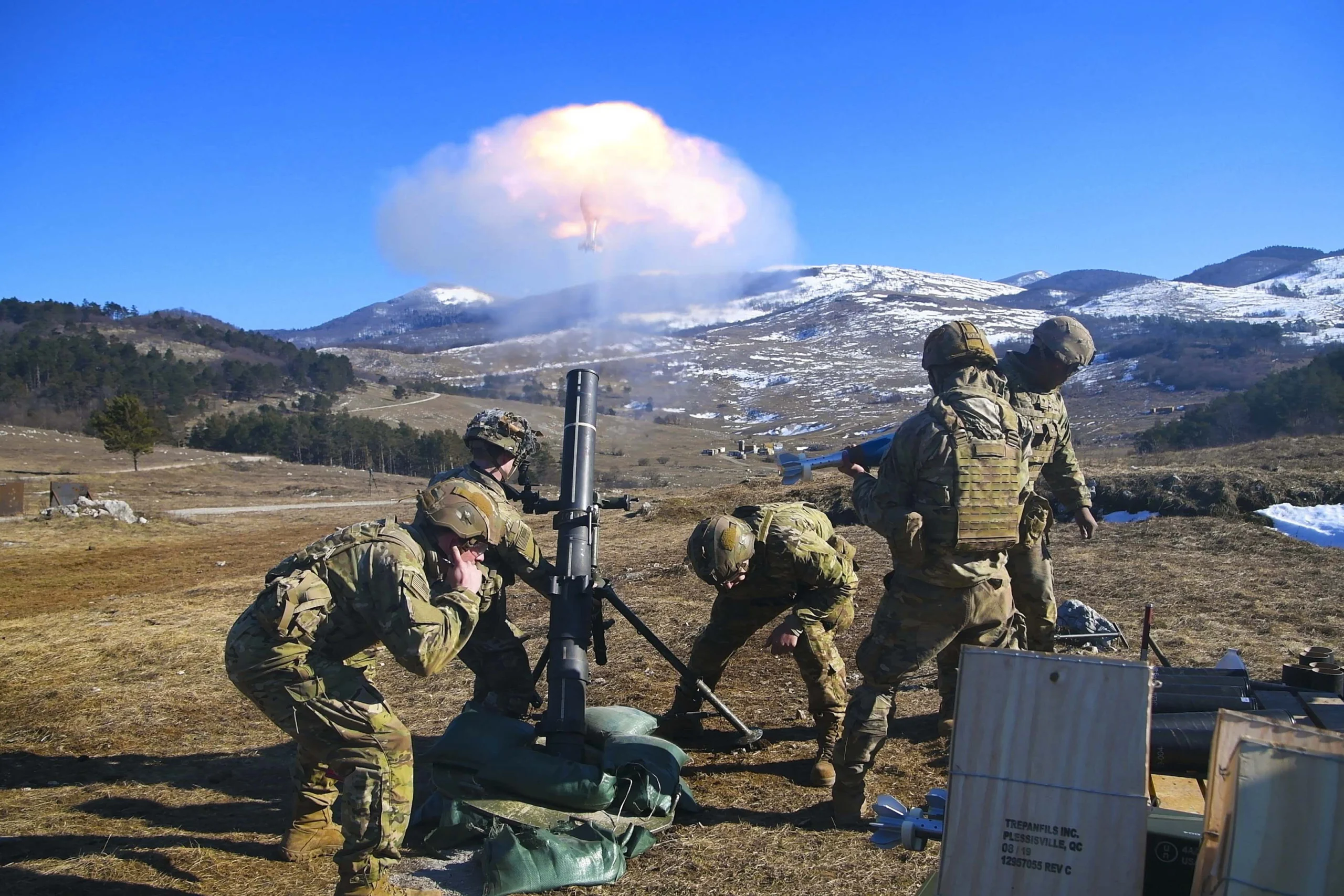 Soldiers firing a mortar system.